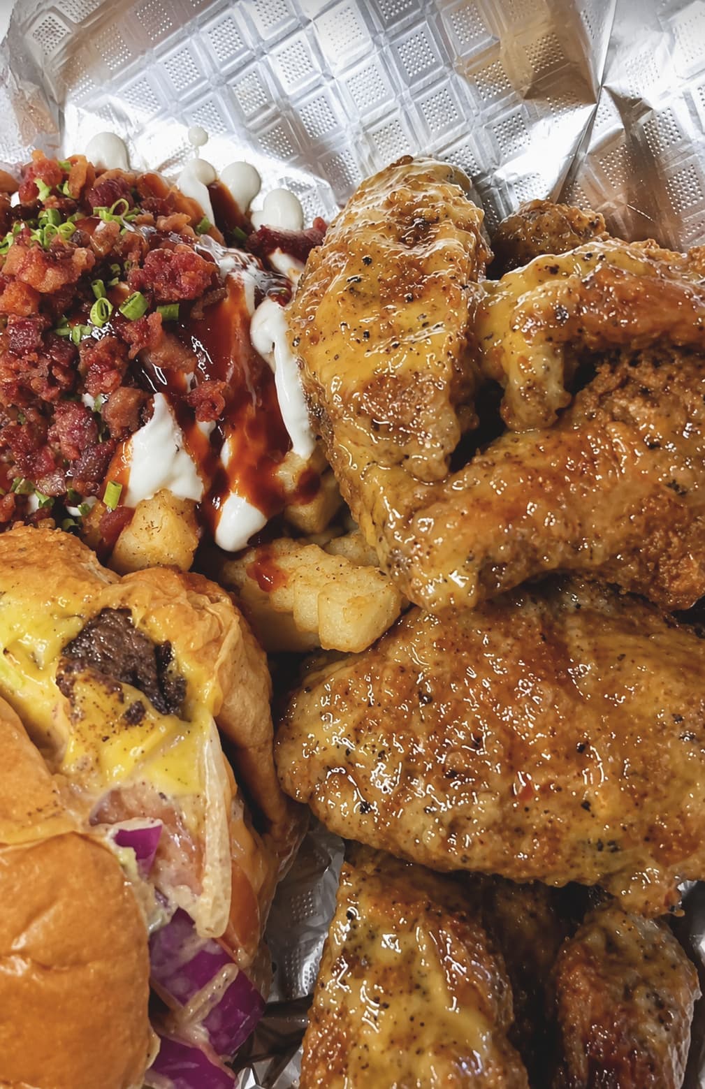 The Trio combo — loaded baked potato, wings, and slider — Lil Moe's Potato Trap Houston food truck
